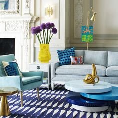 a living room filled with lots of furniture and colorful pillows on top of it's couches