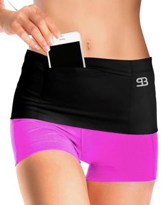 a woman in pink and black shorts is holding a cell phone to her hip pocket