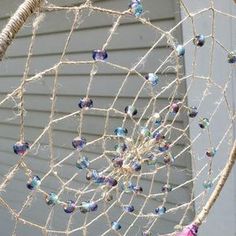 a close up of a net with beads hanging from it's sides and on the outside