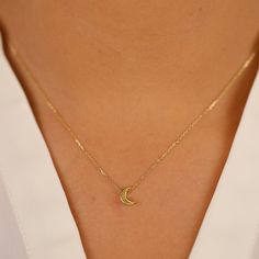 Luna Keep your dreams close with our dainty Mini Plain Gold Moon Pendant Necklace. This celestial charm features a solid 14k gold moon pendant with a touch of thickness for a dimensional look. The minimal design and polished gold finish create a timeless and versatile piece that complements any outfit. Crafted from high-quality 14k gold (available in yellow, white, or rose gold), this necklace offers long-lasting durability and a touch of luxury. - Handmade- Solid Gold- Size of Moon: 7 x 5 mm- The thickness of the Moon: 2 mm All pieces come beautifully boxed in suede pouches you can always use when traveling! Small Gold Pendant Designs, Minimal Pendant Necklace, Minimal Gold Jewelry, Small Pendant Necklace, Minimal Pendant, Pendant Minimalist, Minimal Gold, Gold Moon Necklace, Star Necklace Gold