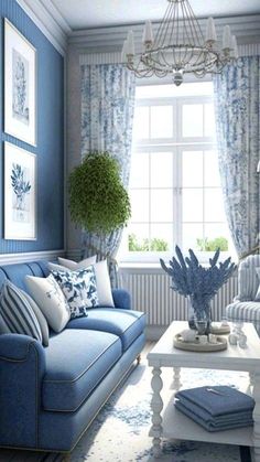 a living room filled with blue furniture and pillows on top of a white coffee table