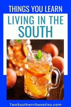 a mason jar filled with liquid and garnished with orange slices, mint leaves and lemon wedges