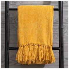 a yellow towel hanging on a black ladder