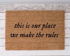 a door mat that says, this is our place we make the rules on it