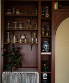 an open bookcase with vases and other items on the shelves in front of it