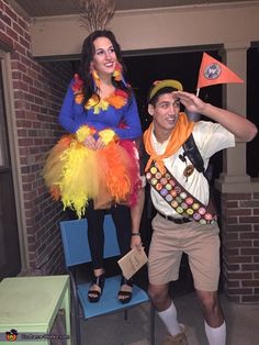 a man and woman dressed in costumes standing next to each other with flags on their heads