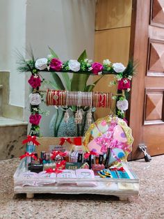 a table topped with lots of different types of cosmetics and flowers on top of it