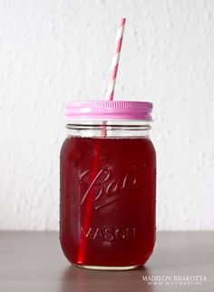 a mason jar with a straw in it