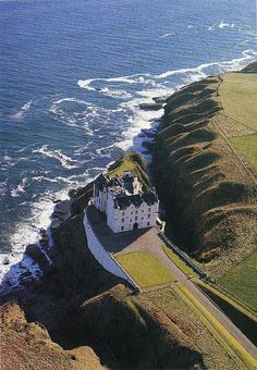 an aerial view of a castle on the coast