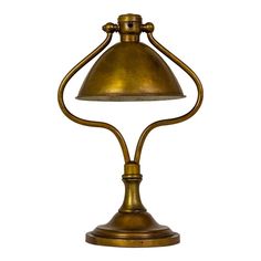 an antique brass desk lamp with a white background