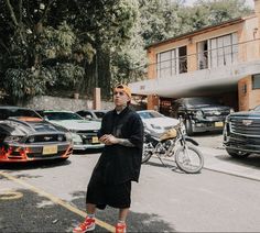 a man standing in the middle of a parking lot