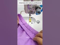 the sewing machine is working on the purple shirt