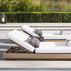 an outdoor chaise lounge with cushions and pillows