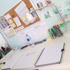 an open planner book sitting on top of a desk next to some tape and scissors