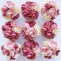 cupcakes with pink frosting and white flowers are arranged in a square pattern