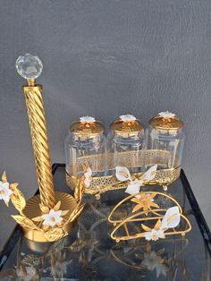 a glass table topped with gold and white items