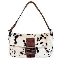 FENDI Baguette Calf Hair Cow Print Shoulder Bag Editor Note：Elevate your style with this exquisite FENDI Baguette shoulder bag, featuring a unique calf hair cow print design. Crafted from premium materials, it combines durability with high fashion. The neutral tones make it a versatile accessory, perfect for adding a touch of sophistication to any outfit. Despite its compact size, it offers ample space for your essentials, making it an ideal choice for both everyday use and special occasions. The bag’s very good condition ensures it remains a timeless addition to your collection, with minor signs of wear adding character to its story. SKU NUMBER：#24112547 MATERIAL：Pony Hair MEASUREMENT W28 x H14.5 x D4 cm HANDLE DROP:N/A STRAP DROP:15 cm COLOUR：Neutral ACCESSORIES：None CONDITION：Very good Small Cute Bags, Jamaica Birthday Trip, Sparkle Lingerie, Cow Print Purse, Vintage Fendi Baguette, Fendi Mini Bag, Fly Jewelry, Cow Print Bag, Cow Print Design