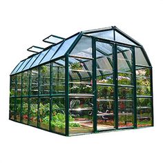 a large green house with many plants inside on a white background in front of the camera