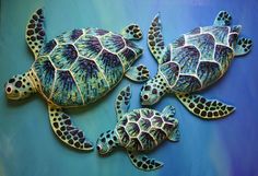 three sea turtles painted in blue and green