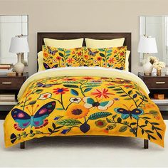 a bed with yellow comforter and matching pillows