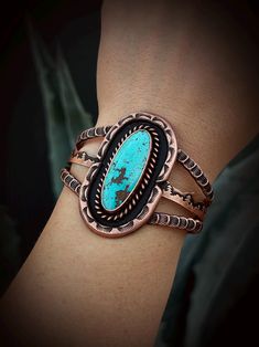 This cuff is 100% solid Copper and features mountain scenery with intricate stamp work that has been hammered by hand. The genuine turquoise is a gorgeous baby blue color! Would make a perfect gift for the turquoise collector or anyone who appreciates statement jewelry!🖤 ◈ MEASUREMENTS Length: 5-1/4 inches Width: 1-7/8 inches Stone size: 37x18 mm ◈ ADJUSTABLE SIZE The Copper has been annealed, so it's fairly flexible and can be adjusted to fit your wrist ◈ SUITABLE FOR YOUR BIG DAY This design Artisan Blue Stamped Bracelets, Artisan Blue Engraved Cuff Bracelet, Artisan Engraved Blue Bracelets, Blue Stamped Bracelet As Gift, Adjustable Blue Engraved Cuff Bracelet, Real Turquoise Jewelry, Arm Bracelet, Silver Turquoise Jewelry, Metalwork Jewelry