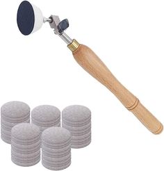 a set of four round discs and a wooden mallet with an air vent on top