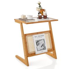 a wooden table with a magazine rack on top of it next to a cup and saucer