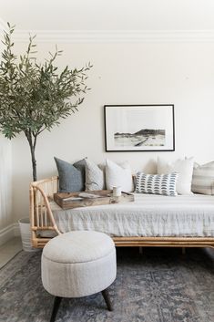 a living room filled with furniture and a tree in the corner on top of it