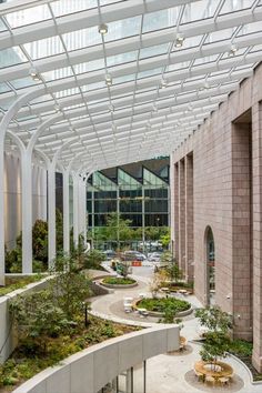 the inside of a building with lots of plants