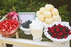 an assortment of desserts and pastries on display at a wedding or bridal party