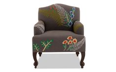 an upholstered chair with floral designs on it