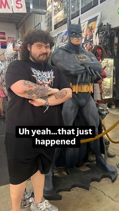 a man standing next to a statue of batman and the caption reads, uh yeah that just happened