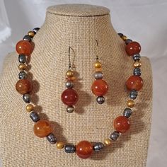 This 16" Choker Style Necklace Has A Huge Amount Of Genuine Carnelian! Look At The Size Color Of These 1/2" Round Beads That Pop With Various Colors Of Orange To Red. Carnelian Stone Chips Accent The Necklace Along With Dyed Gold And Pewter Colored Fresh Water Pearls And Seed Beads. Beautiful Hand Crafted Closure Is Made With Gold Filled Wire. Matching Pierced Earrings Measure 1 1/2" And Hang From French Ear Wires. Gorgeous Statement Necklace To Wear With A Collared Button Up Blouse Or With A To Red Carnelian, Coord Set, Choker Style Necklace, Pearl Necklace Earrings, Stone Chips, Pewter Color, Carnelian Stone, Carnelian Beads, Fresh Water Pearls