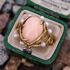 This enchanting coral is crafted in 14k yellow gold and features an oval cabochon cut angel skin coral surrounded by a textured gold leaf motif and eight cultured pearls. The ring is currently as size 6.75. Coral, Angel Skin, Vintage Angel, Leaf Motif, Gold Texture, Oval Cabochon, Pearl Ring, Cultured Pearls, Gold Leaf