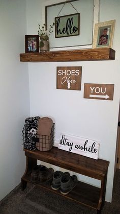 a wooden bench with shoes on it next to a wall