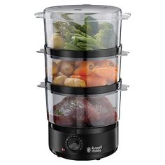 the food steamer is stacked high on top of each other with different foods in it