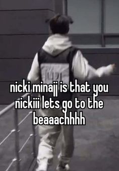 the back of a person walking down a sidewalk with text that reads nicki mina is that