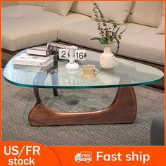 a glass coffee table sitting on top of a carpeted floor