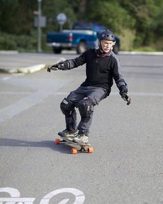 a man riding a skateboard down the middle of a street