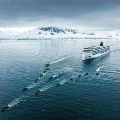 a cruise ship sailing in the ocean with skis on it's back end