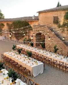 an outdoor dining area with tables and chairs set up for a formal function in the evening