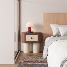 a bedroom with a bed, night stand and lamp on the side table next to it