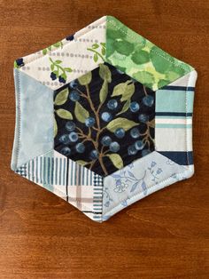 a patchwork piece with blueberries and leaves on it