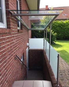 an outside view of a brick building with glass railings