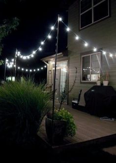 an outdoor patio with lights strung from the roof and on to the side of the house