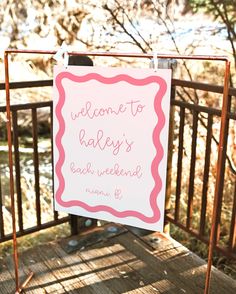 a pink and white sign that says welcome to baker's bush weekend on it