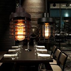 a dining room with tables, chairs and an industrial light fixture