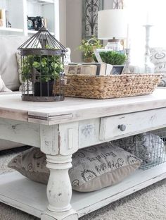 a white coffee table with baskets on top