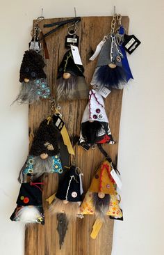 a wooden board with several different types of key chains hanging from it's sides