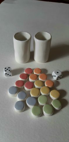 two cups and several dices on a table